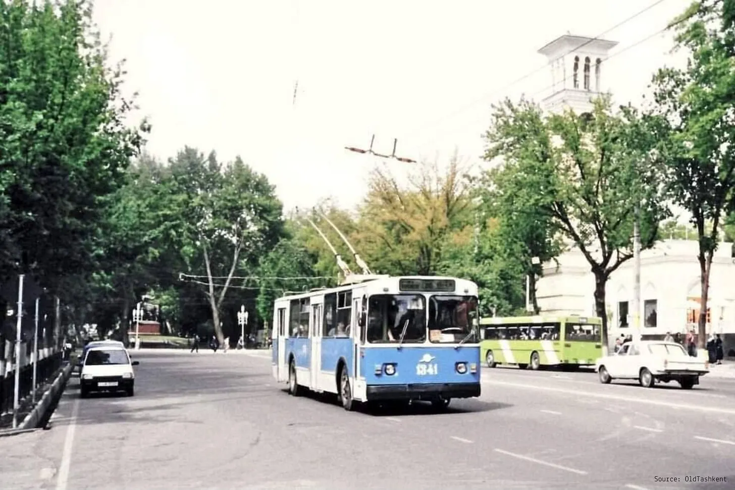 A blue trolleybus on a tree-lined street in Tashkent
